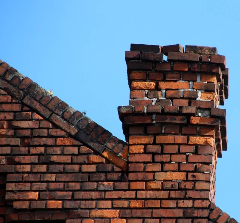 Damaged chimney on an Bensenville home showing cracks and missing mortar